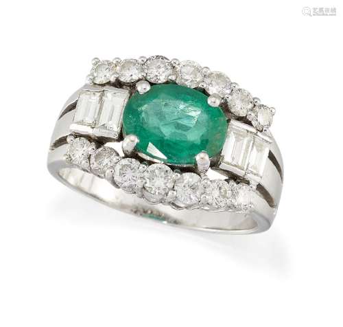 An emerald and diamond ring, the oval-cut emerald with graduated baguette-cut diamond two stone