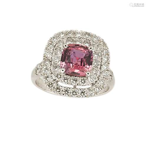 An 18ct gold, garnet and diamond cluster ring, the claw-set cushion shaped mixed-cut garnet with