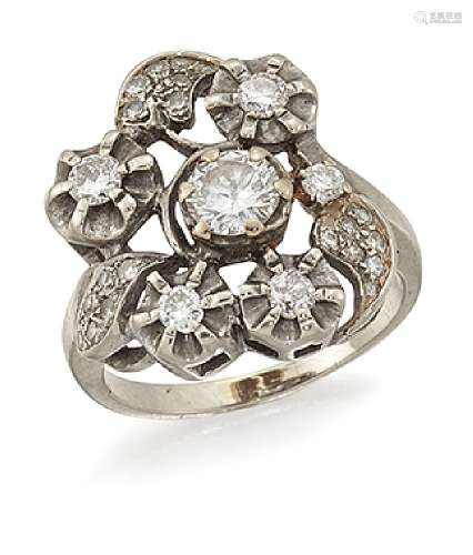 A diamond cluster ring, the claw-set brilliant-cut diamond centre within a surround of four circular
