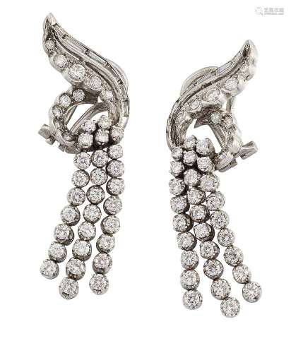 A pair of diamond ear clips, of stylised cluster scroll design with graduating rows of circular