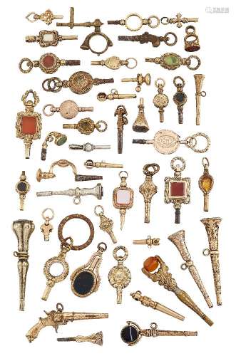 A collection of pocket watch keys of various designs, including a pistol and a rotating seal,