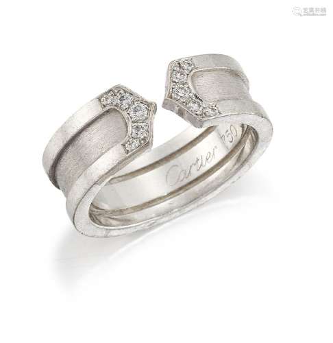 A diamond ring, by Cartier, the wide brushed metal band to pave diamond chevron points designed to