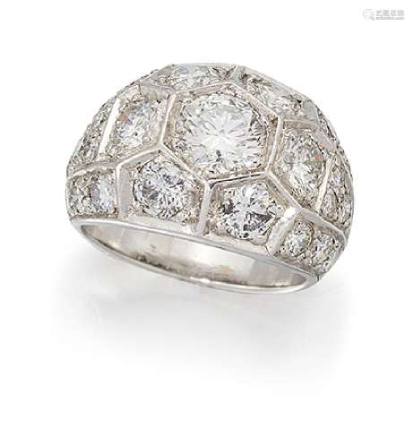 A diamond cluster ring, of brilliant-cut diamond 'honeycomb' set bombé cluster design to pavé
