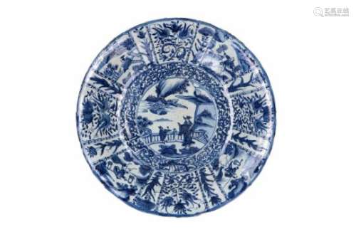A blue and white 'kraak' porcelain deep charger, decorated with reserves depicting figures in