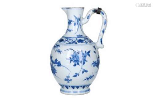 A blue and white porcelain jug with silver mounting, decorated with flowers. Unmarked. China,
