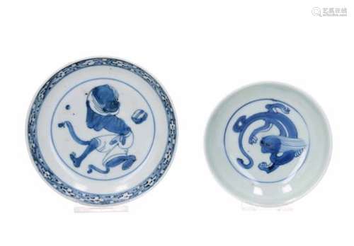 Two blue and white porcelain saucers, decorated with a dragon and a mythical creature. Marked.