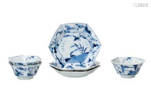 A set of three hexagonal blue and white porcelain cups with saucers, decorated with ducks, flowers