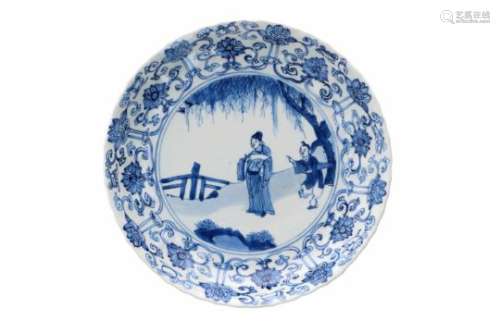 A lobed blue and white porcelain deep dish with scalloped rim, decorated with a dignitary and