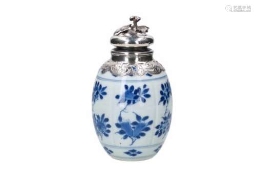 A blue and white porcelain tea caddy with 19th century silver mounting, decorated with flowers.