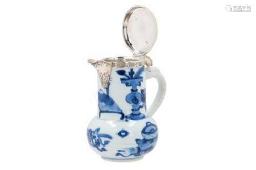 A blue and white porcelain jug with silver mounting, decorated with antiquities. Unmarked. China,