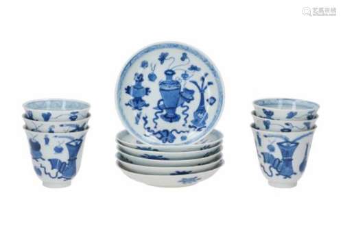 A set of six blue and white porcelain cups with saucers, decorated with antiquities and flowers.