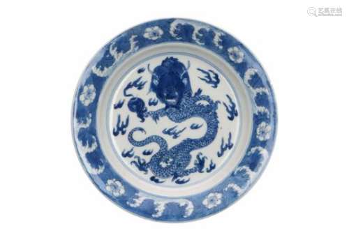 A blue and white porcelain deep saucer, decorated with a dragon with burning pearl, censers and