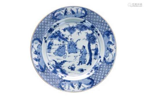 A blue and white porcelain charger, decorated with Taoist musicians and their servants in a