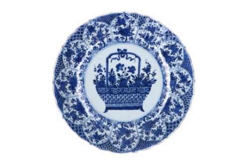 A blue and white porcelain deep charger, decorated with a flower basket and flowers. Marked with