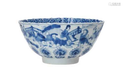 A ribbed blue and white porcelain bowl with scalloped rim, decorated with long Elizas and playing