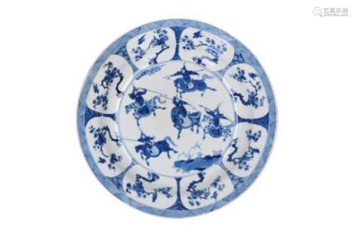 A blue and white porcelain deep charger, decorated with horsemen, flowers and birds. Marked with 6-