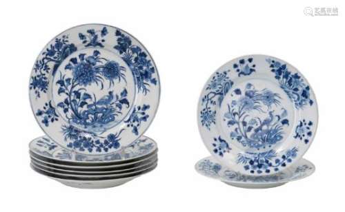 A set of eight blue and white porcelain dishes, decorated with a bird and flowers. Marked with 6-