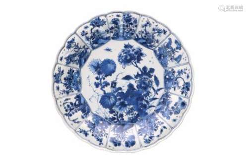 A lobed blue and white porcelain deep charger with scalloped rim, decorated with flowers. Marked