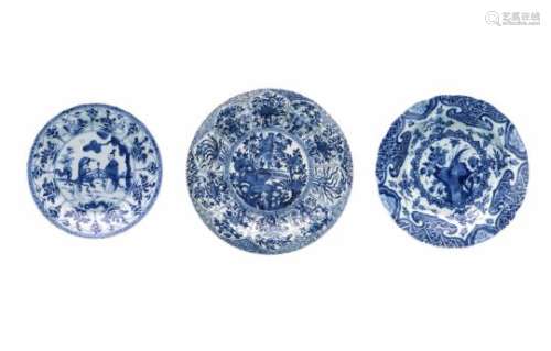 Lot of three blue and white porcelain dishes, 1) decorated with a bird on a rock and flowers.