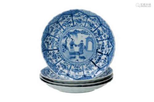 A set of four lobed blue and white porcelain dishes, decorated with figures on a bridge and flowers.