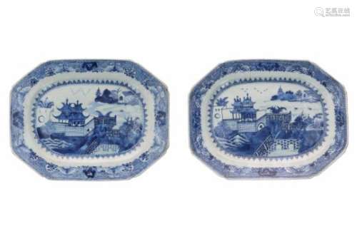 A pair of octagonal blue and white porcelain serving dishes, decorated with buildings in a river