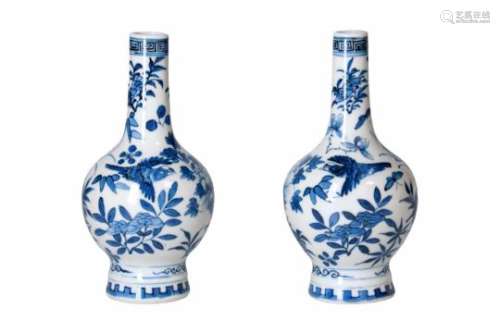 A pair of blue and white porcelain vases, decorated with flowers and birds. Marked with 4-