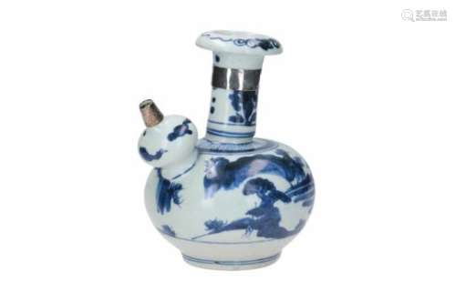 A blue and white porcelain kendi with silver mounting, decorated with a landscape. Unmarked.