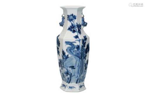 A hexagonal blue and white porcelain vase, decorated with a bird and flowers. Marked with 4-