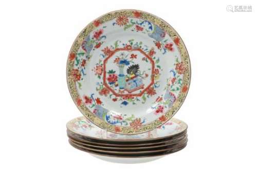 A set of six polychrome porcelain dishes, decorated with flowers, a flower vase and scrolls.