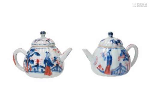 A pair of ribbed Imari porcelain teapots, decorated with a figure on a terrace. Unmarked. China,