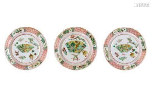 A set of three famille verte porcelain saucers, decorated with antiquities and a landscape. Marked