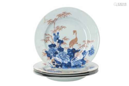 A set of four blue and white porcelain dishes with gilded decor of flowers and a crane. Unmarked.