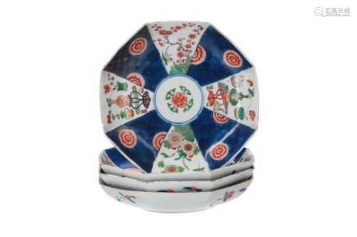 A set of four octagonal famille verte porcelain dishes, decorated with animals, flower vases and