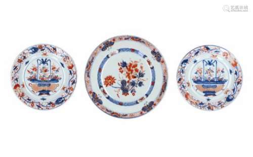 A pair of Imari porcelain deep dishes, decorated with butterflies and a flower vase. Unmarked.