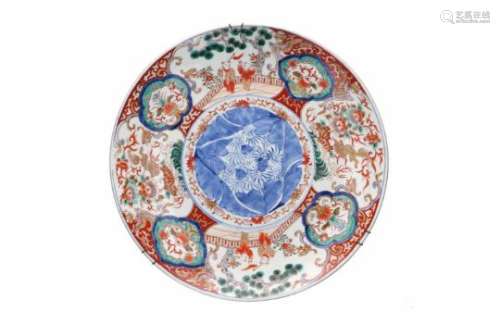 An Imari porcelain charger, decorated with flowers, dragons, phoenixes, lions and scenes with little