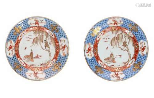 A pair of blue and iron red porcelain dishes, decorated with long Eliza and little boys in a garden.