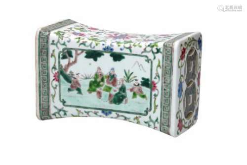 A famille verte porcelain opium pillow, decorated with figures in a garden and flowers. China,