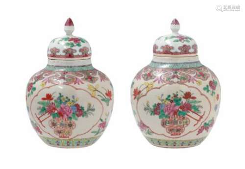 A pair of famille rose porcelain ginger jars, decorated with flowers, fruits and flower vases.