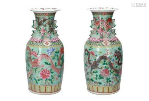 A pair of polychrome porcelain vases, decorated with dragons in relief, flowers and dragons