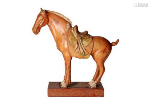 A polychrome terracotta sculpture of a horse on wooden base. China, Tang or later.