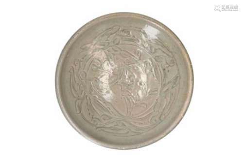 A celadon glazed porcelain bowl with carved decor of flowers. Unmarked. China, Northern Song,