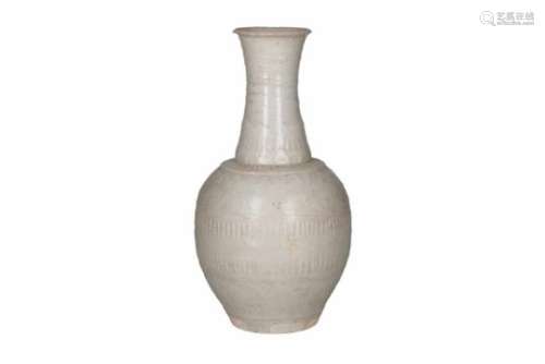 A qingbai glazed porcelain bottle vase, decorated with flowers and vertical carving. Unmarked.