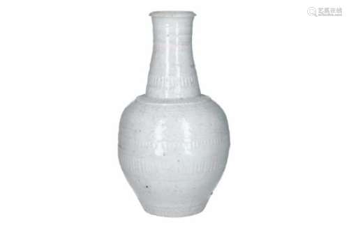 A qingbai glazed porcelain bottle vase, decorated with flowers and vertical carving. Unmarked.