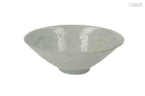 A celadon glazed bowl, with carved decor of clouds. Unmarked. China, Song/Ming.