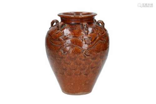 A brown glazed earthenware martaban storage jar, decorated with dragons. The base inscribed with