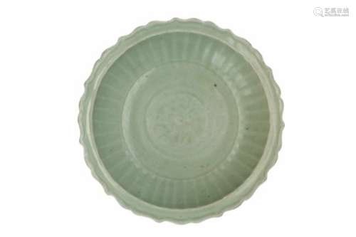 A celadon glazed porcelain deep charger with scalloped rim and relief decor. Unmarked. China, 14th/