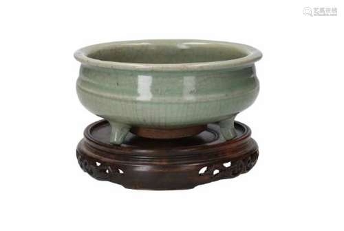 A tripod celadon glazed censer, on wooden base. Marked. China, 18th/19th century.