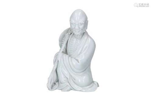 A blanc de Chine sculpture of a sitting monk with attributes. Unmarked. China, Dehua, 19th