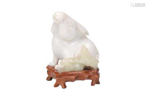 A celadon and mutton fat jade sculpture of a hare group, carved from one piece. On wooden base.