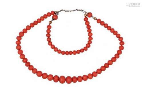 A red coral necklace with partly golden clasp. The necklace can be split up in a seperate bracelet